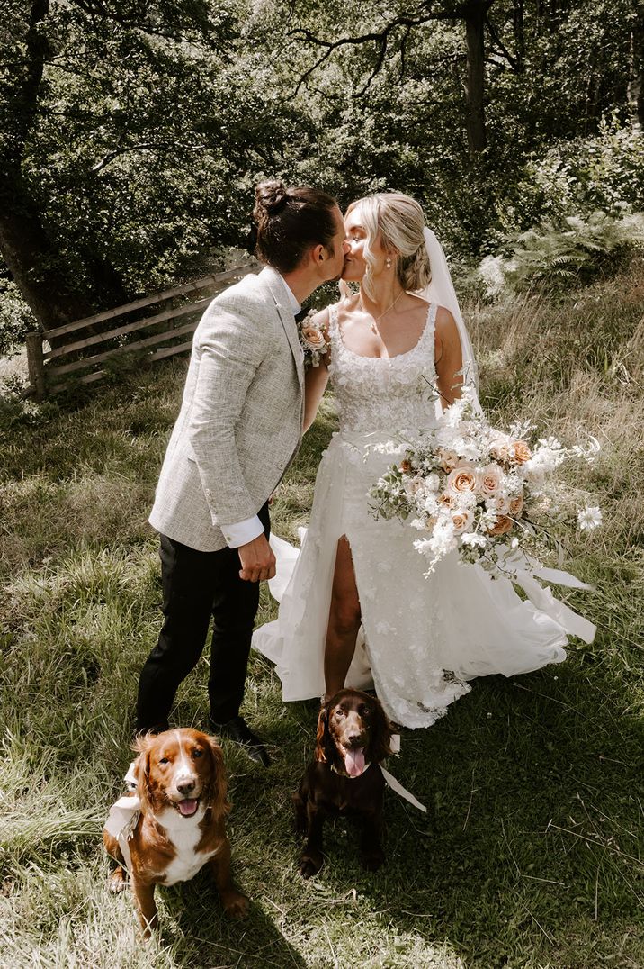 Bride in 3D floral eleganza esposa wedding dress carrying neutral wedding bouquet with groom in light grey suit 