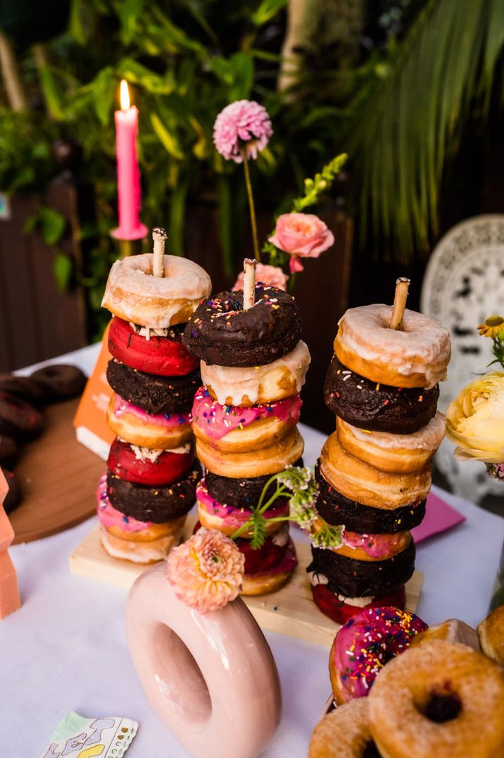 Engagement party theme based on sweet treats with stack of doughnuts 