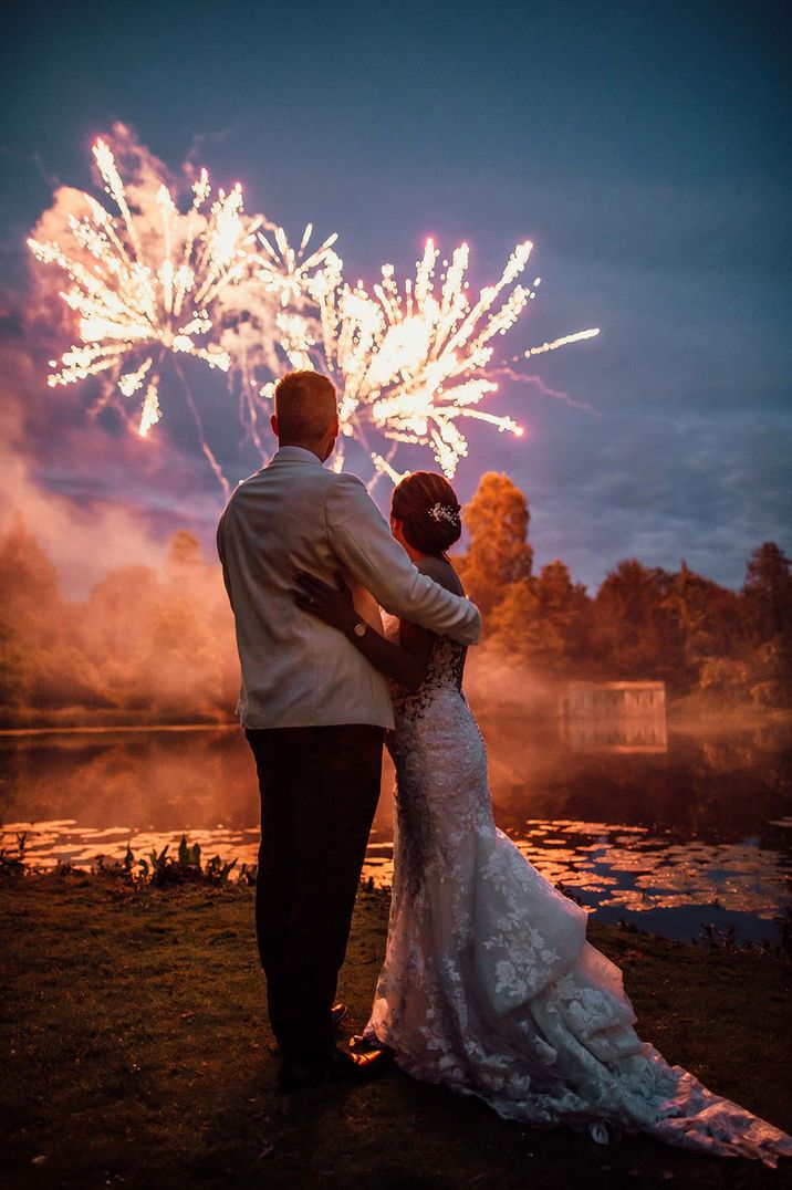 The happy couple gaze out at the view lit up by the incredible fireworks 