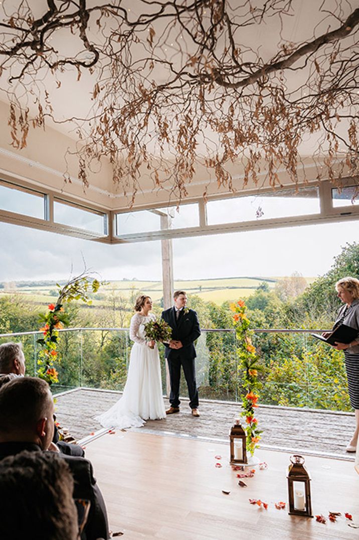 Tree Top Escape wedding venue in Devon with incredible views of the rolling hills with autumnal leaf altar decoration 