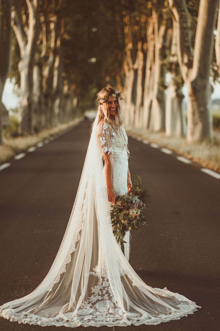 The bride wears a handmade wedding dress with a flower crown for a boho wedding 