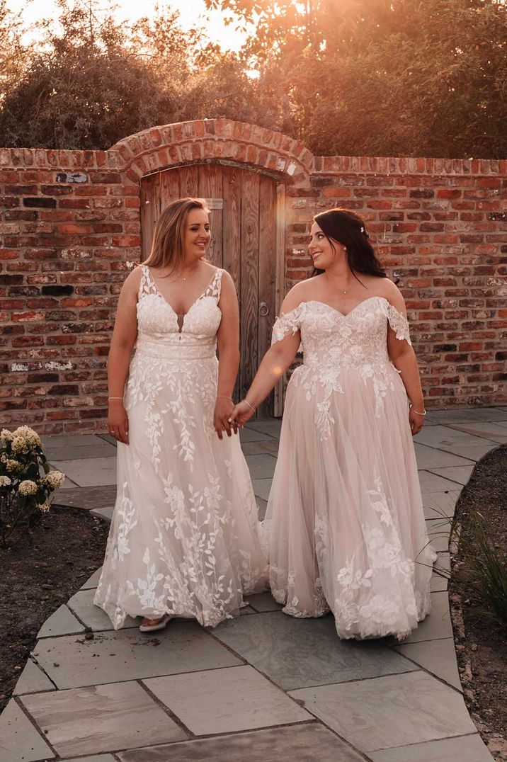 Brides in complimenting lace wedding dresses at The Oakwood at Ryther wedding venue 