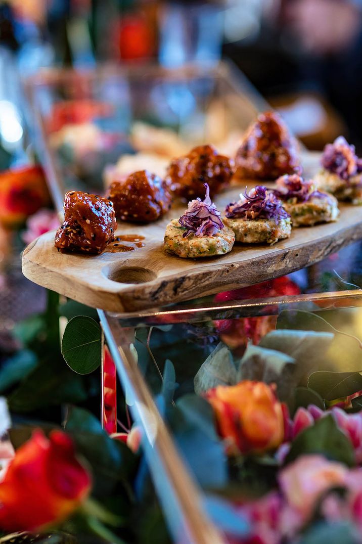 Asian herbed salmon fishcakes with Asian slaw on a wooden sharing platter for fun and relaxed wedding breakfast 