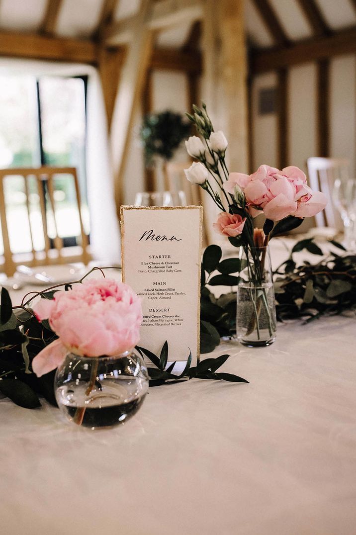 Bud vases with pink peony wedding flowers in for table decorations 