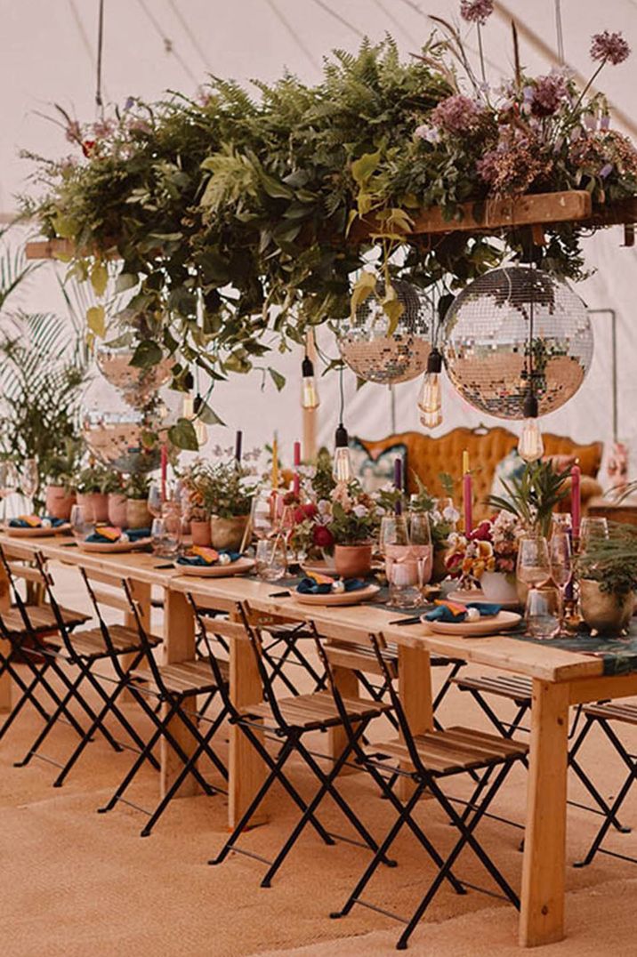 Marquee at Bespoke at Littleton Manor Farm outdoor events space with disco balls, hanging festoon lighting and bright decorations 