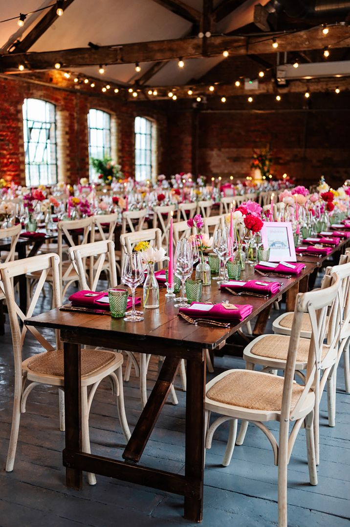 Pink theme wedding with pink table decorations and place settings at industrial wedding venue in London 