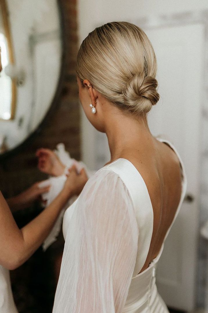 Bride with her blonde hair in a sleek bun for wedding day 