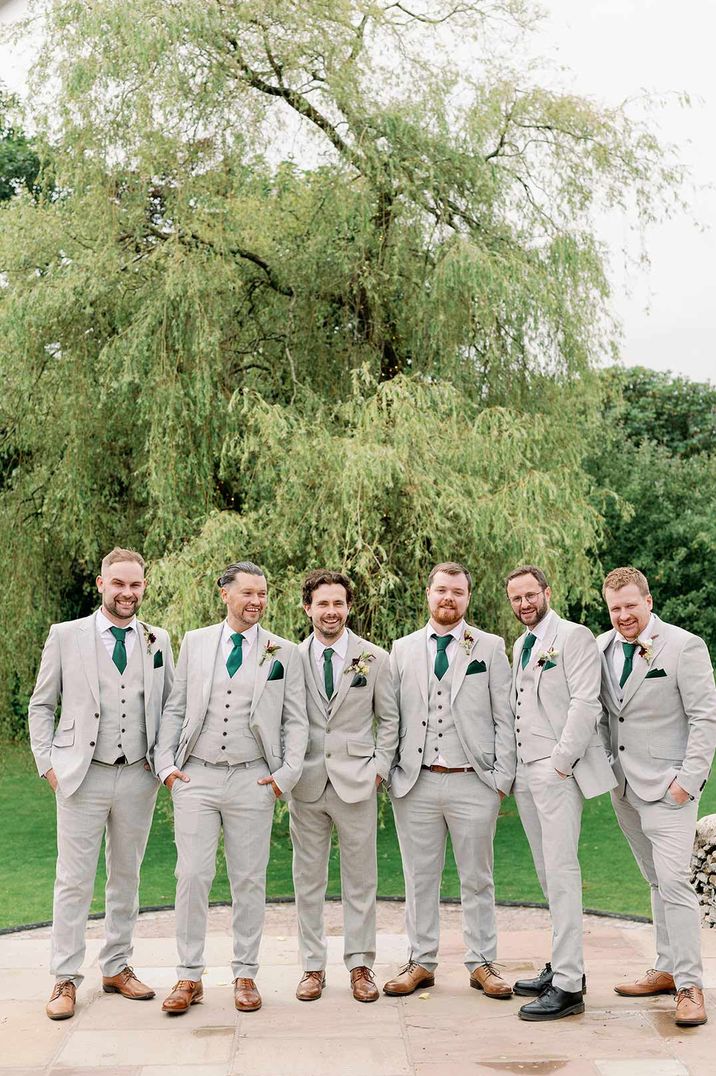 Groom and groomsmen in light grey suits 