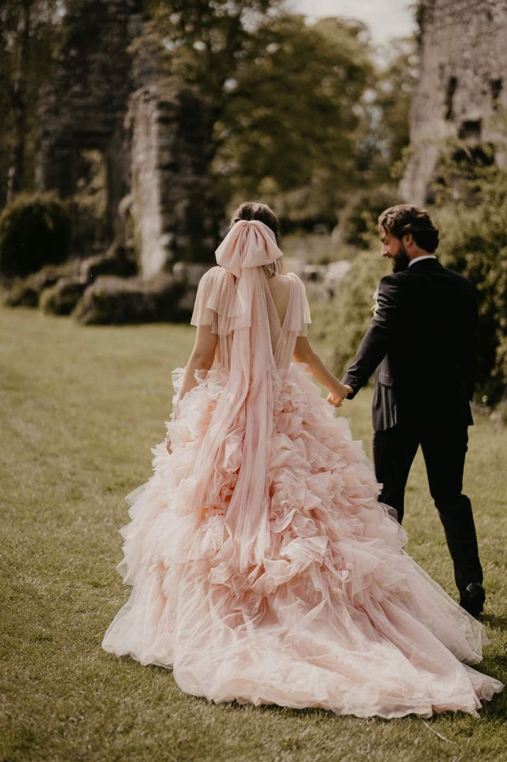 Pink coloured wedding dress with matching pink bow wedding veil 