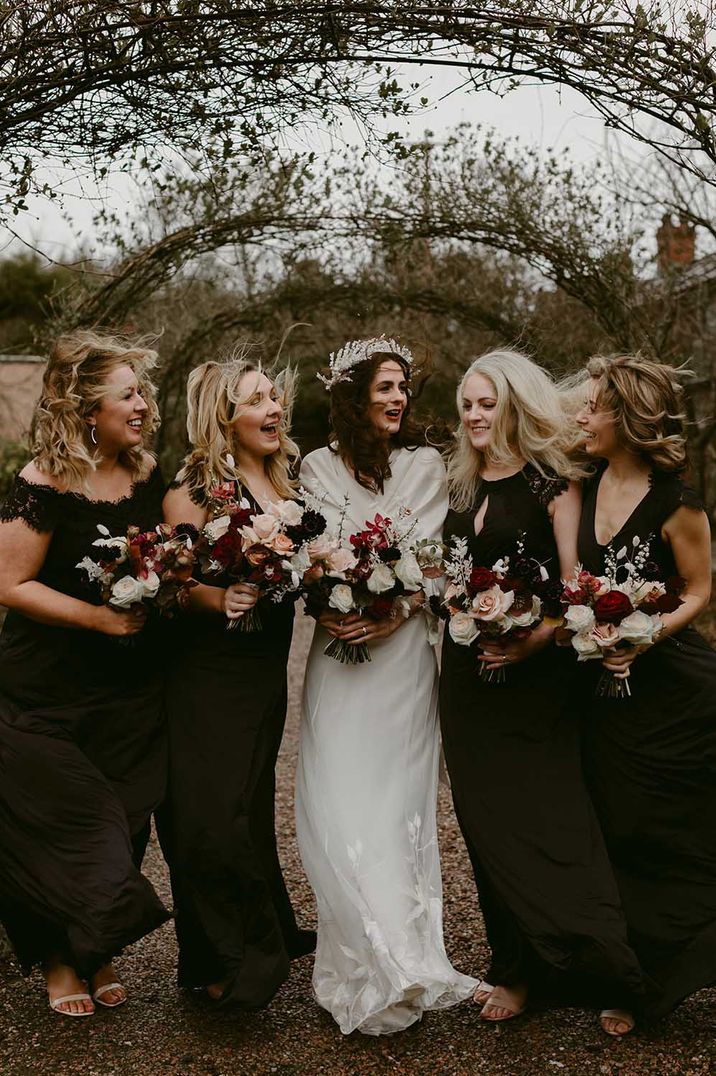 Irish winter wedding with black bridesmaid dresses and red and white bouquets 