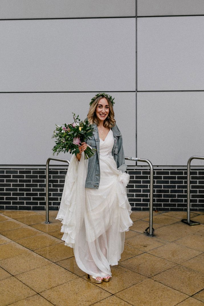 Boho bride wearing a flower crown and light blue bridal denim jacket for London wedding 