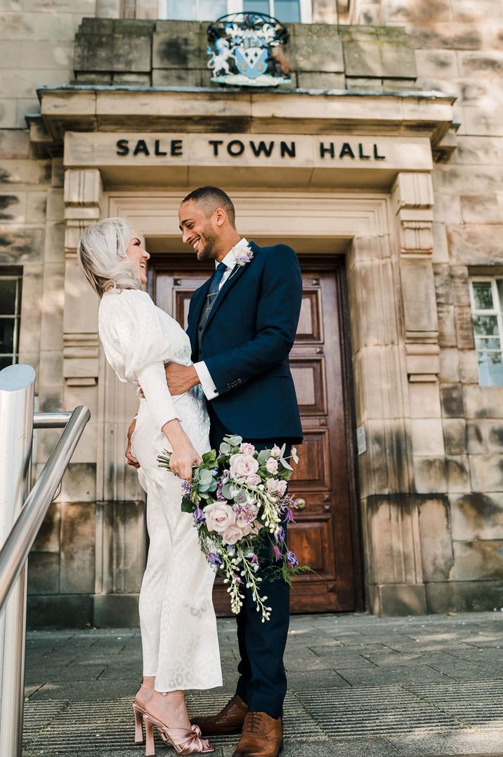 Bride and groom in the steps of Sale Registry Office 