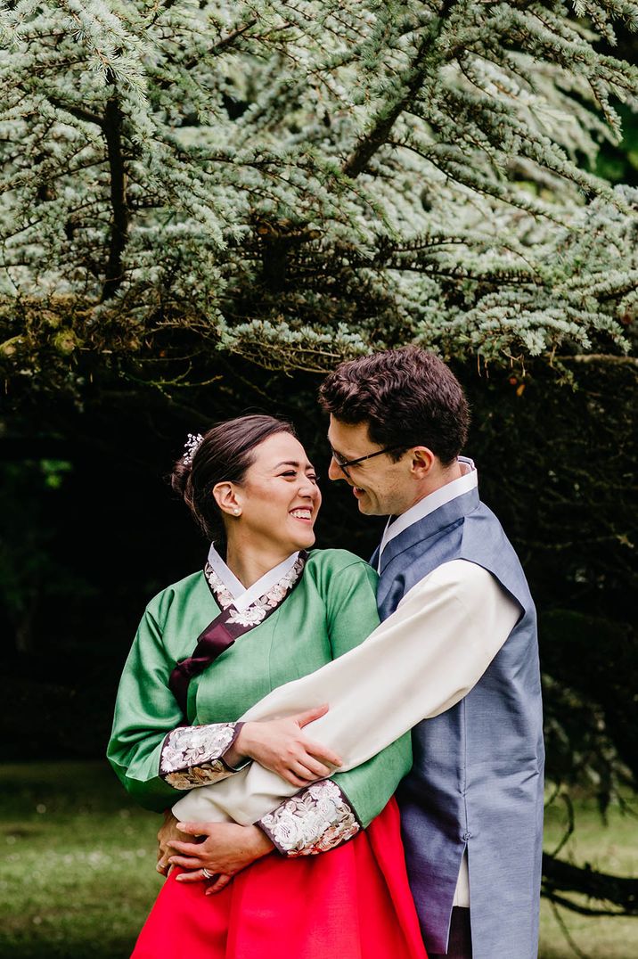 Bride and groom in traditional Korean wedding attire 