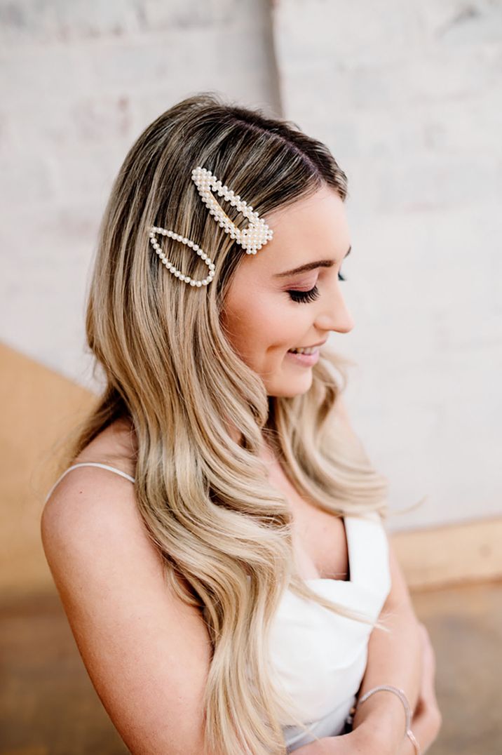 Blonde bride wears pearl embellished hair slides 