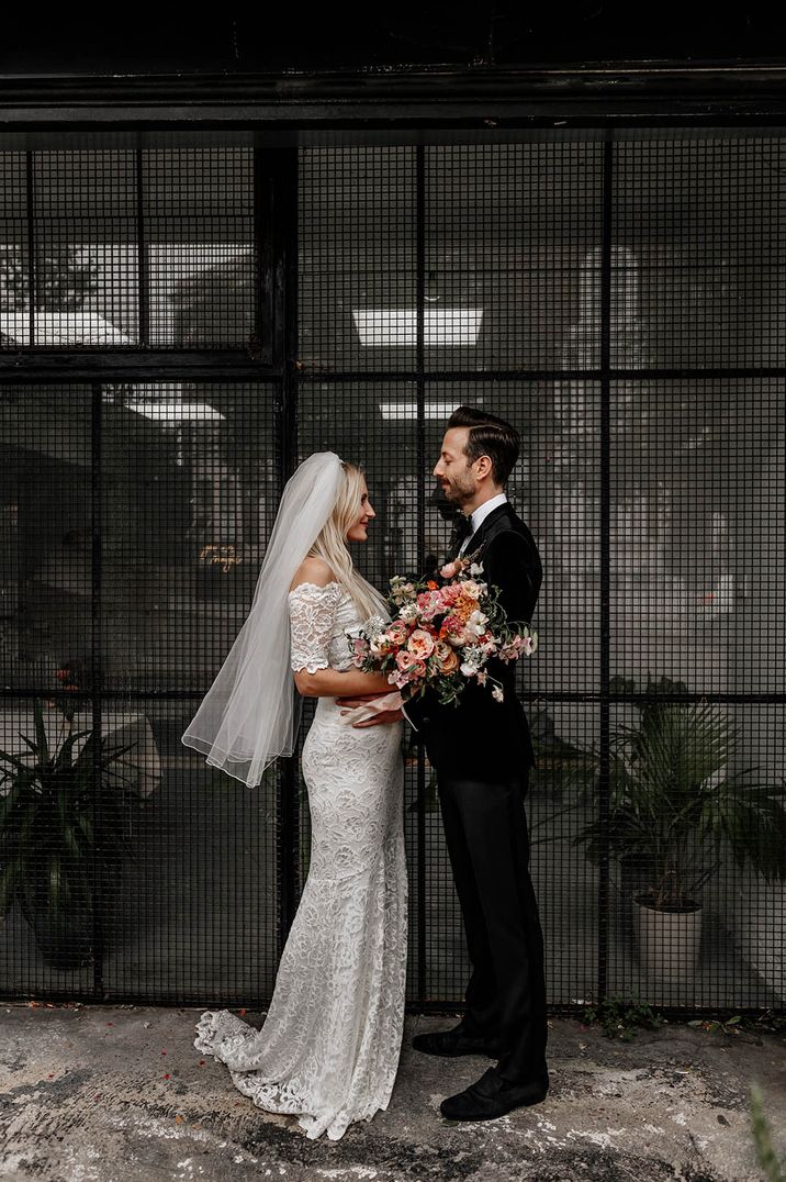 Bride in boho Grace Loves Lace bridal two piece with the groom in black tie for city wedding 