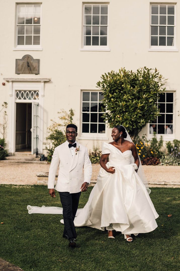 Black-tie wedding with groom in a white tuxedo and bride in a strapless princess wedding dress