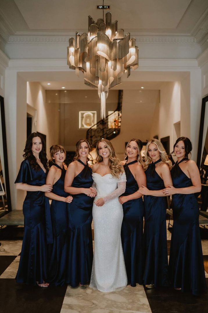 bridal party in navy blue bridesmaid dresses and a sparkly wedding dress at ski wedding in France 