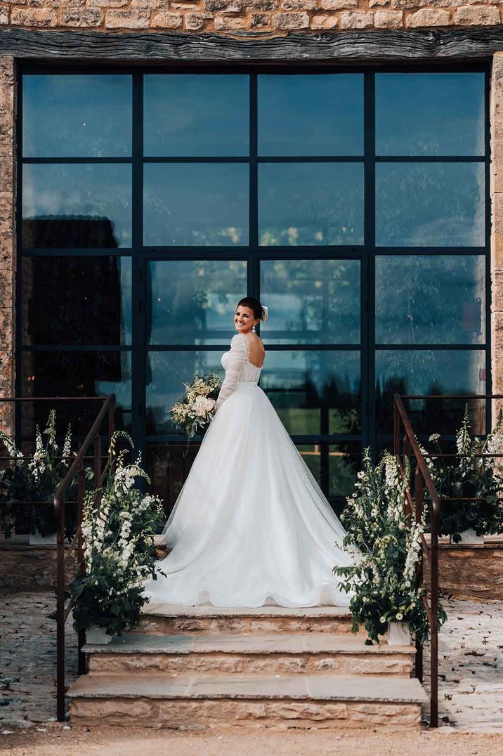 bride in a bespoke Emma Beaumont princess wedding dress with long sleeves