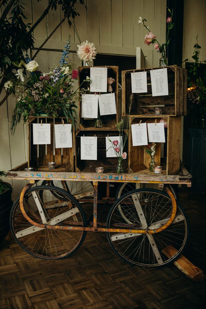 Wooden crate seating chart decorated with colourful flowers