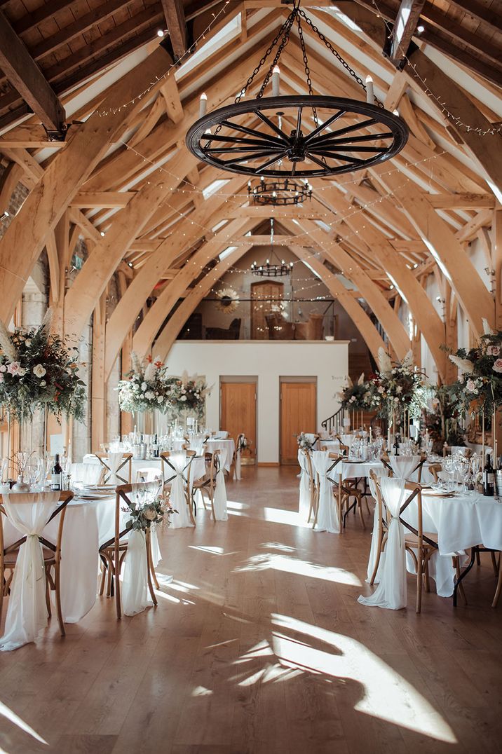 The Saddle Room rustic wedding venue with pink rose table centrepieces 