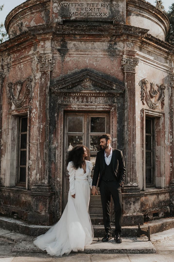 Bride in long sleeve wedding dress with the groom at Larmer Tree Gardens wedding venue 