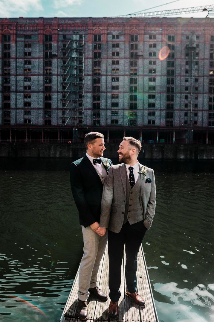 Groom and groom looking lovingly at each other at Stanley Dock