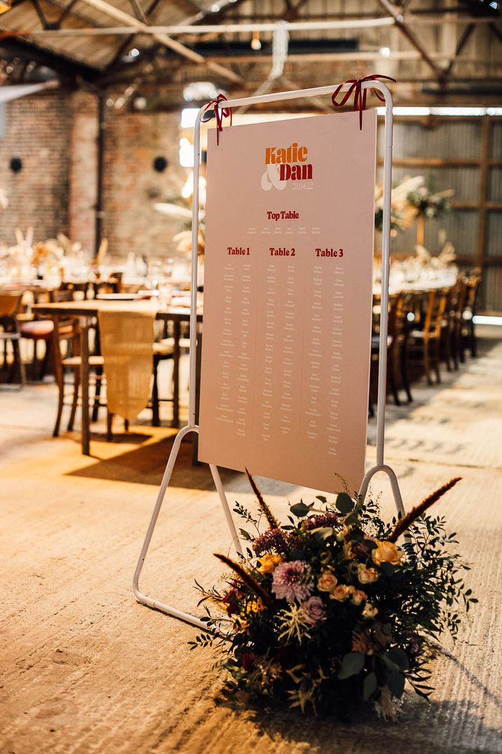 Colourful retro pink, red and white wedding table plan 