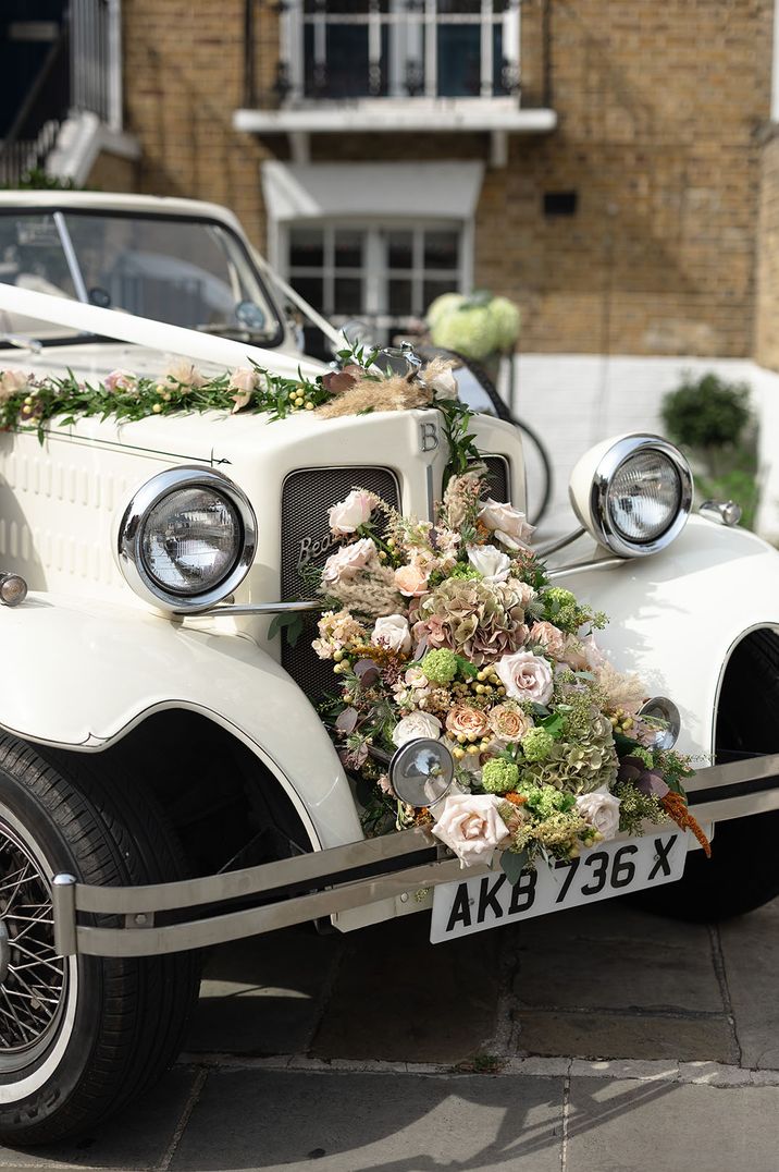 SW Blooms wedding flower arrangement on cream vintage wedding car from AB Chauffeurs 