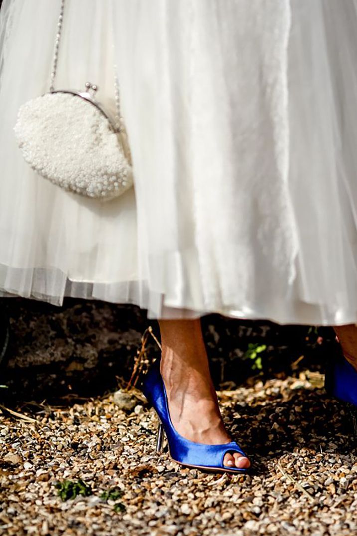 Bride wearing royal blue wedding shoes with puffy white wedding dress by Richard Jones Photography