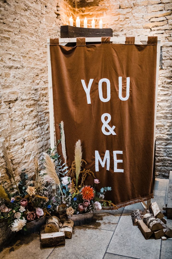 Brown You & Me fabric wedding sign and floral decor for barn wedding 