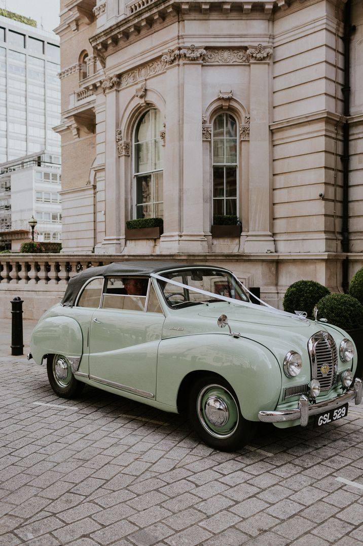 Mint green classic wedding car with white ribbon