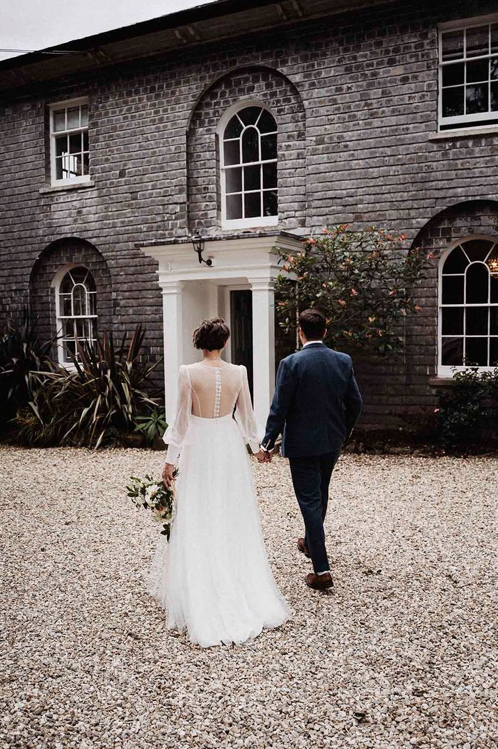 Bride and groom holding hands at Treseren, one of the best UK country house wedding venues