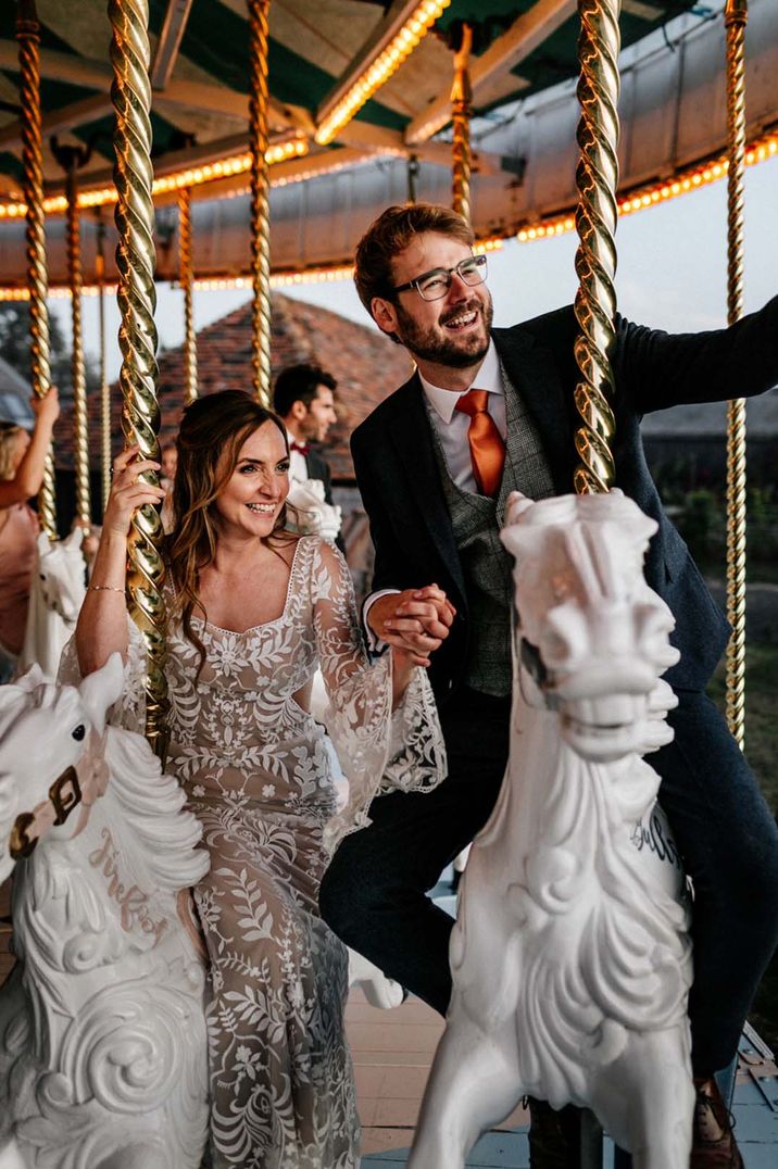 Preston Court wedding with a carousel being ridden by the bride and groom 