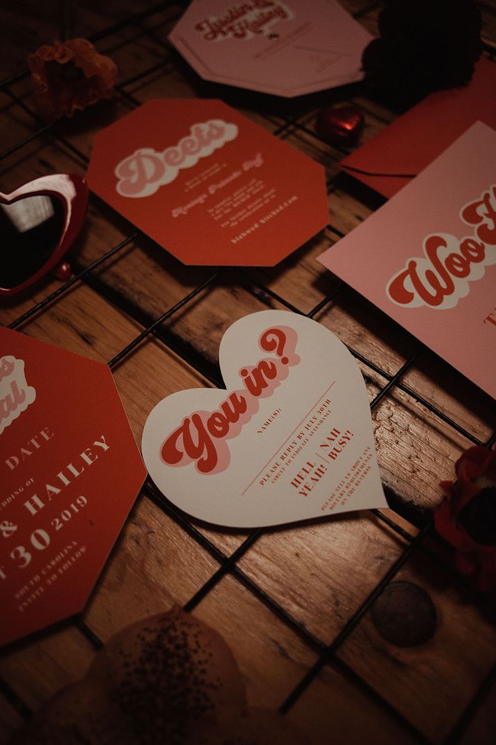 Valentines inspired heart shaped wedding invitation with retro style font 