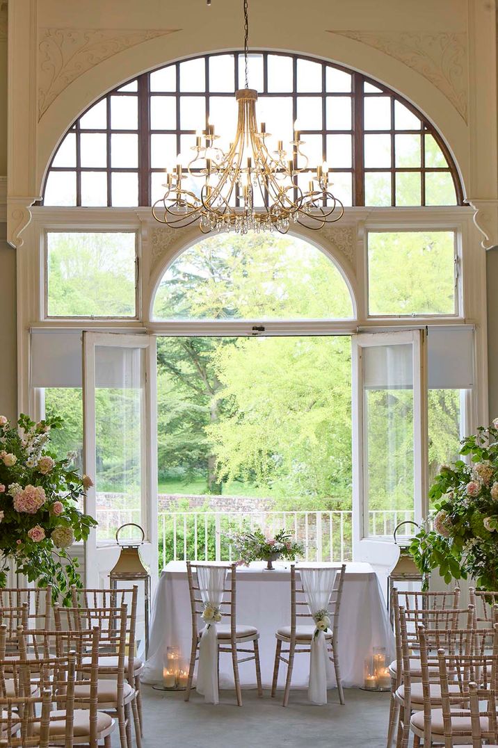 Farnham Castle wedding venue with pink wedding flowers, white drapery, silver lanterns and more 