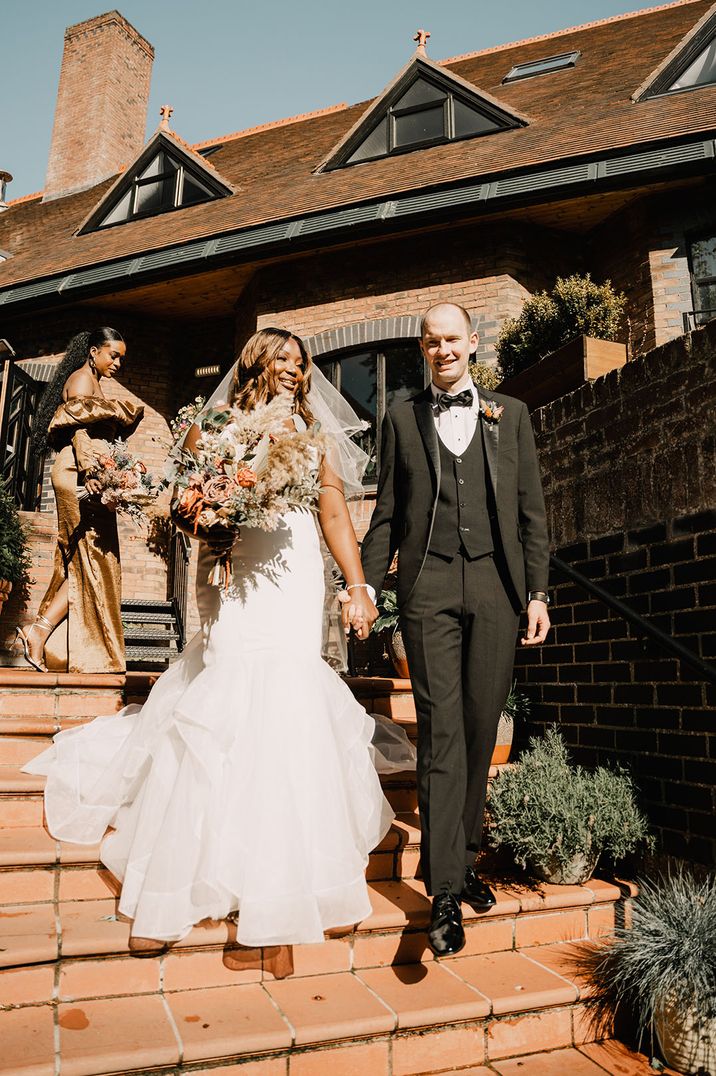 Bride in mermaid style wedding dress with the groom in a black tuxedo at Northern Ireland wedding 