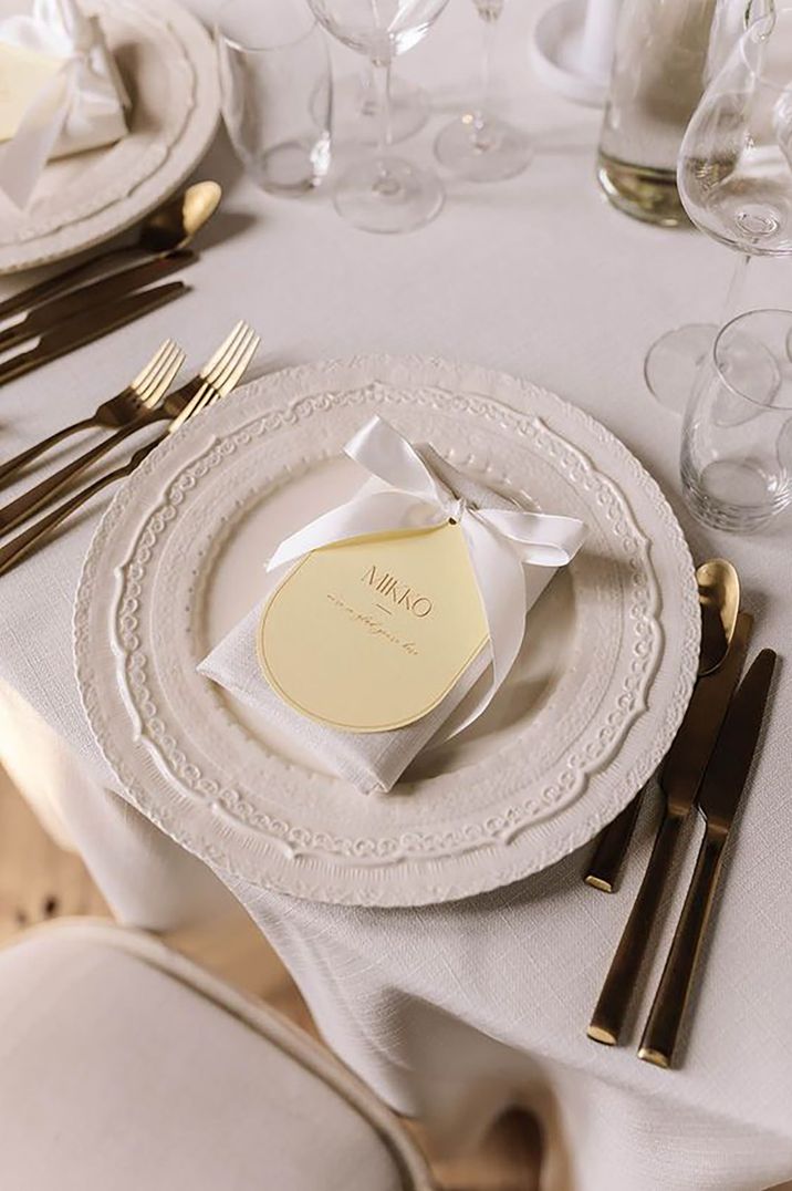 Wedding table set up with plate and table place name with bow decoration by Divine Day Photography