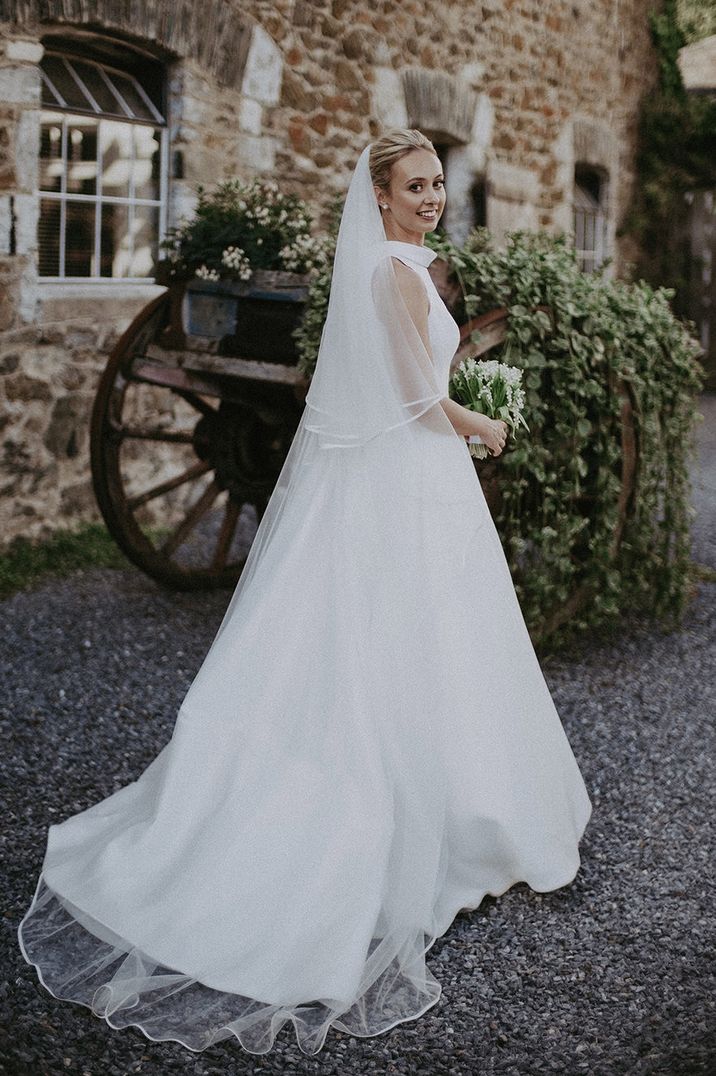 Minimal high neck, sleeveless princess wedding dress by Recommended Supplier Jason Mark Harris Photography