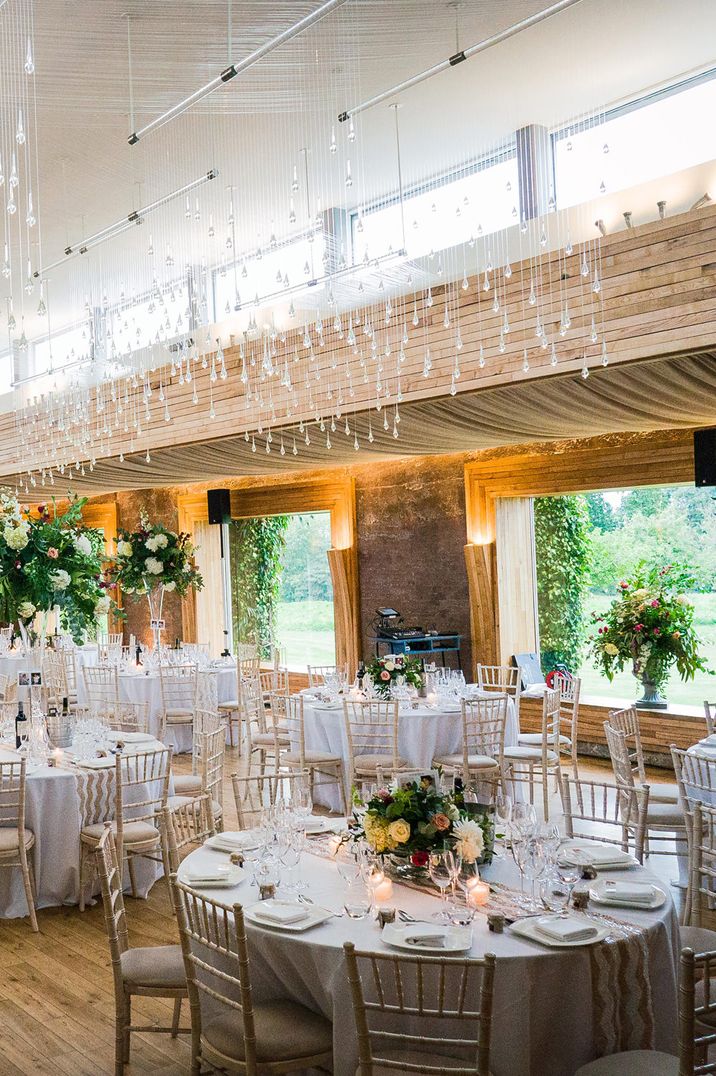 Elegant wedding reception at Elmore court with brightly coloured floral decorations