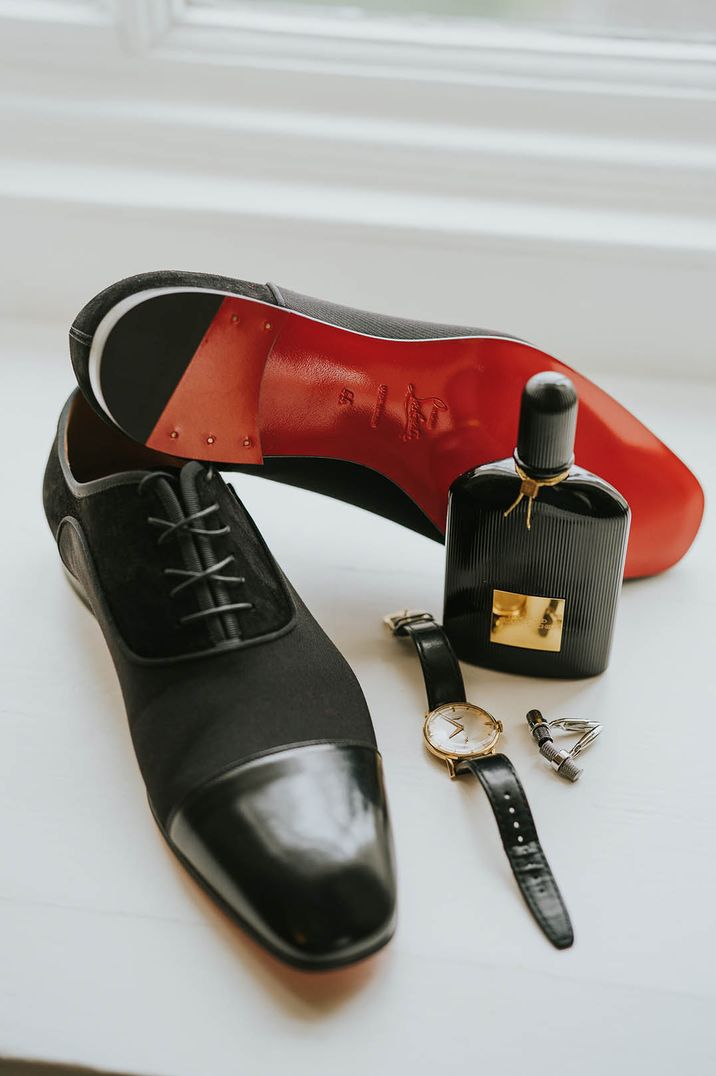 Louboutin groom shoes with black leather watch and silver cufflinks next to the Tom Ford Cologne for men 