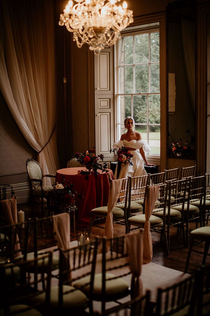 Bride looks out at the ceremony room at Rise Hall