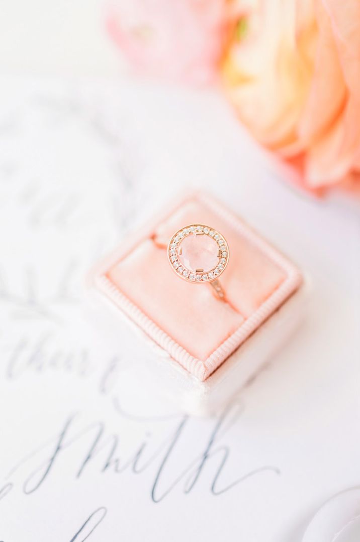 Peach pink velvet square ring box with round engagement ring 