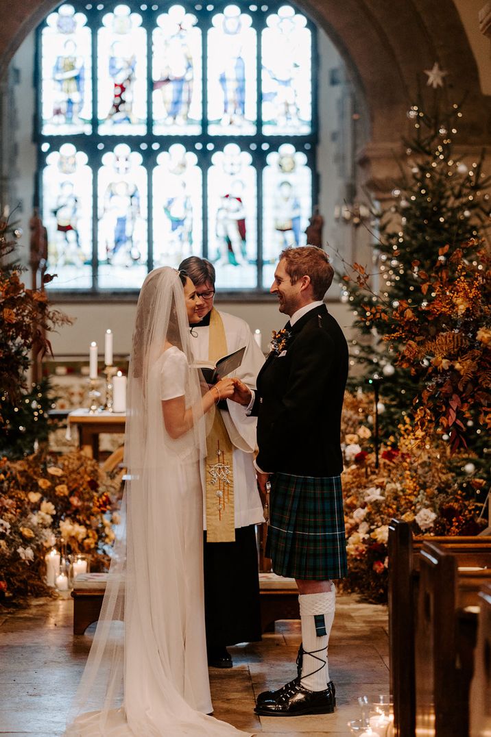 Classic and traditional church winter wedding with Christmas tree decoration 