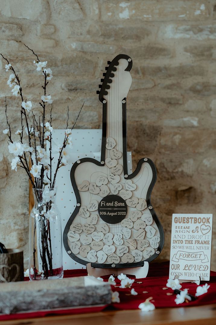 Wooden guitar wedding guest book with small puzzle pieces 