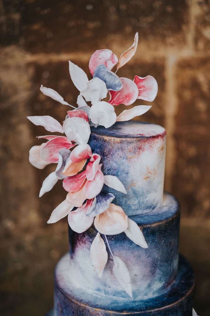 Hand made pastel pink and purple leaves on dark blue and white wedding cake design 