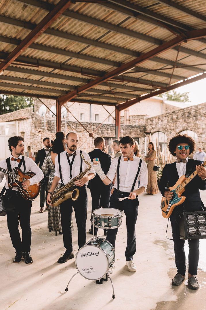 Outdoor destination wedding with live wedding band playing guitar and saxophone 