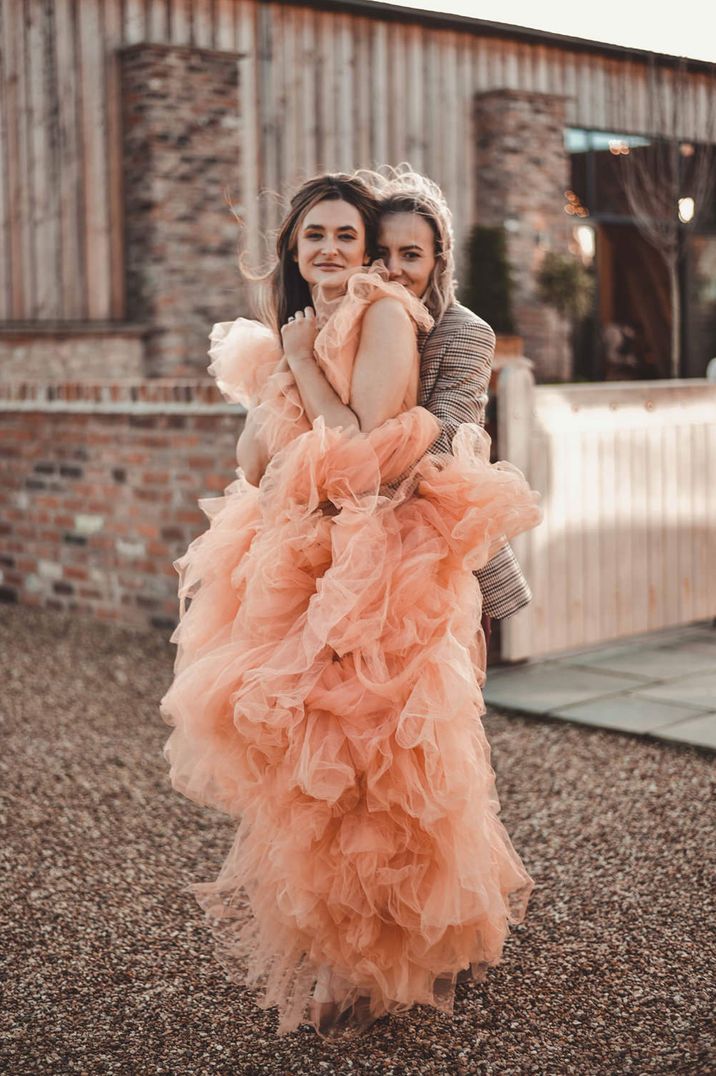 peachy pink coloured wedding dress with tulle ruffles