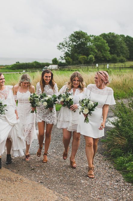 Bride in centre surrounded by best woman and bridesmaids with bouquets