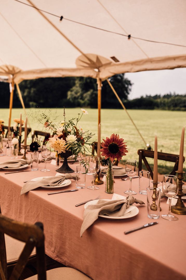 Neutral wedding tablescape with earthy, neutral napkins and plants