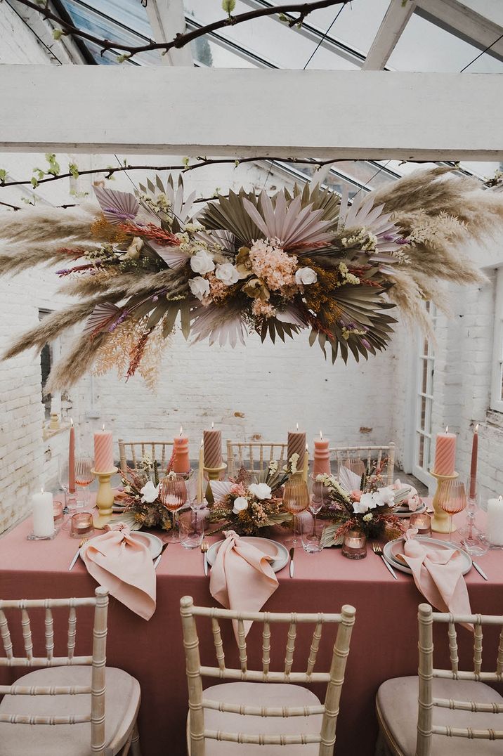 Pastel coloured pampas grass wedding installation with fresh flowers